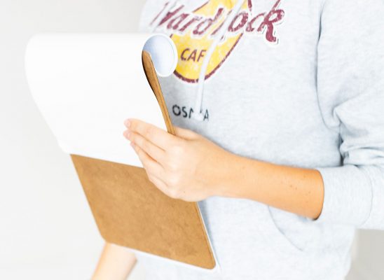 Photo of woman holding clipboard